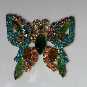 Vintage goldtone metal butterfly brooch multicolored rhinestones attenae figural